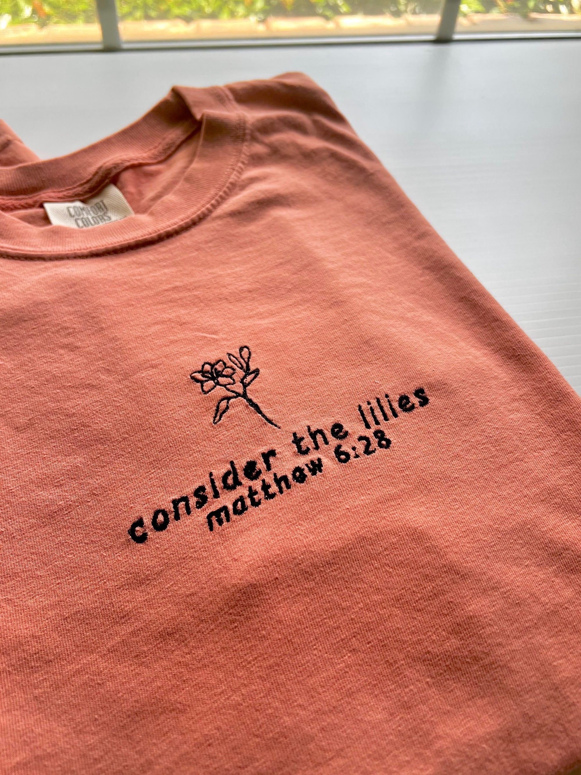 “Consider the Lilies” Comfort Colors T-Shirt | Terracotta
