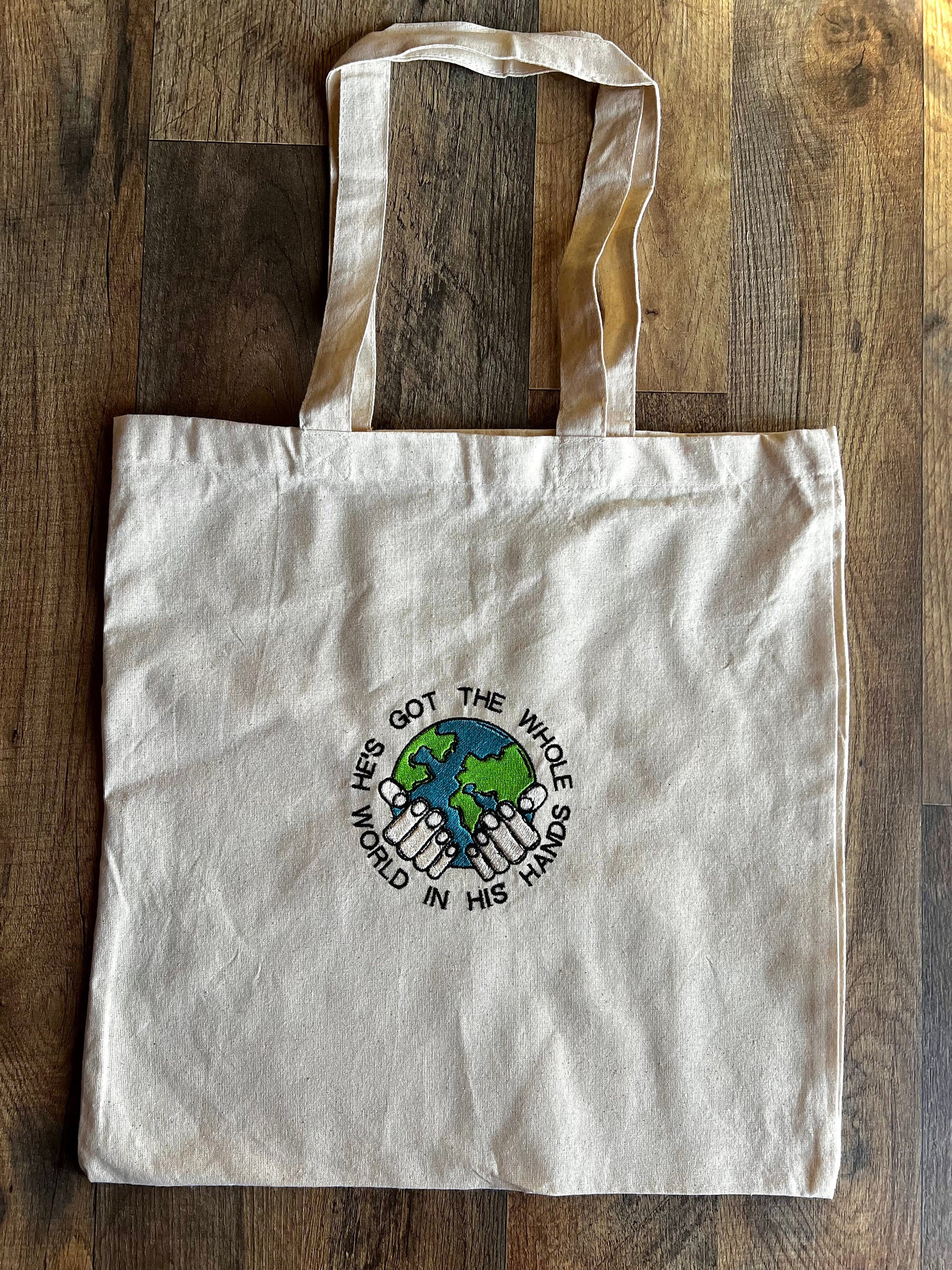 “He’s Got the Whole World in His Hands” Tote Bag